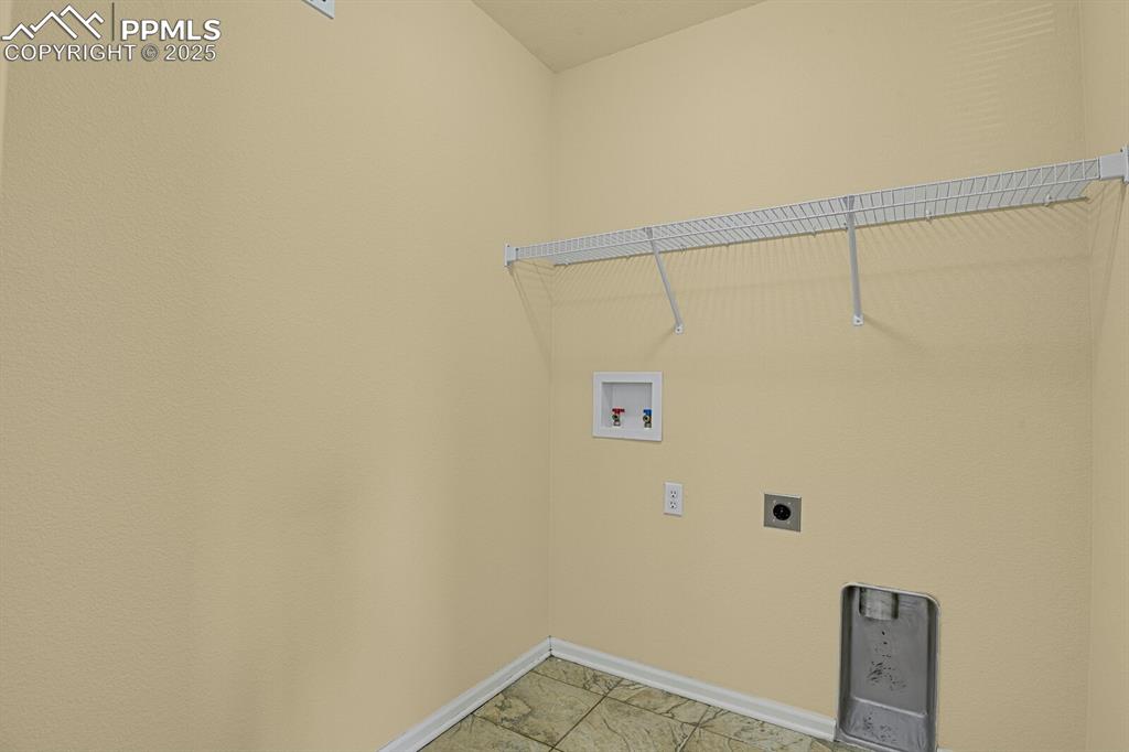 Image 36 of 45: Washroom featuring hookup for an electric dryer, hookup for a washing machi