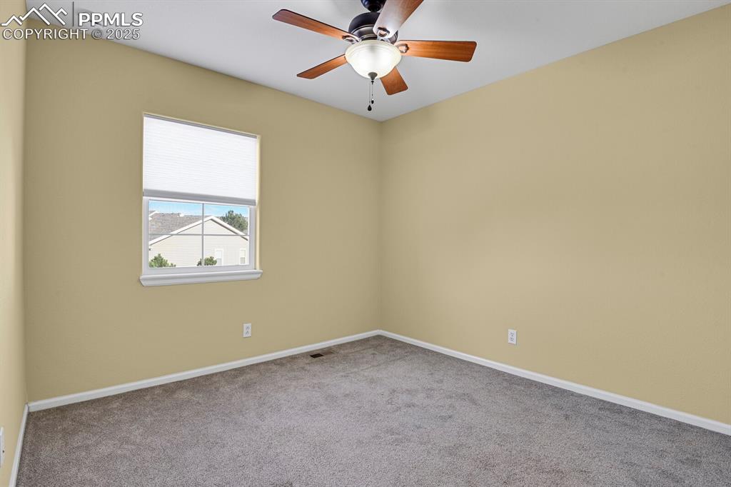 Image 37 of 45: Carpeted spare room featuring baseboards and ceiling fan