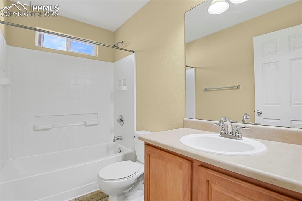 Image 38 of 45: Bathroom featuring vanity, bathing tub / shower combination, and light tile