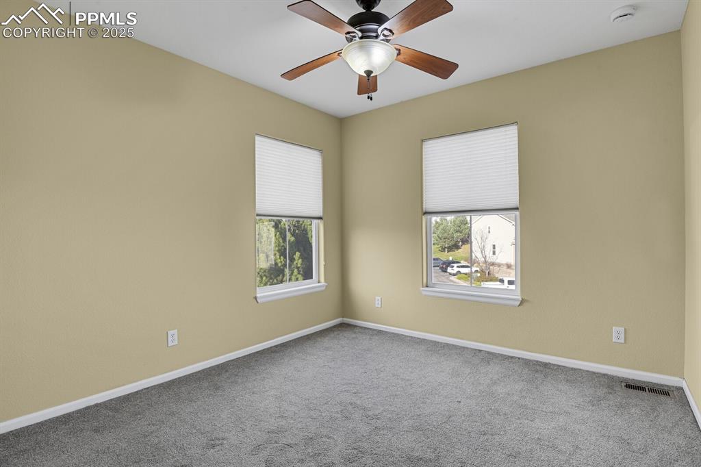 Image 39 of 45: Carpeted empty room with baseboards and ceiling fan
