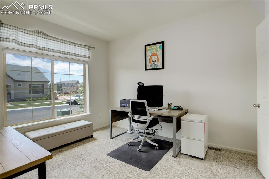 Image 20 of 29: Front secondary bedroom wtih walk-in closet