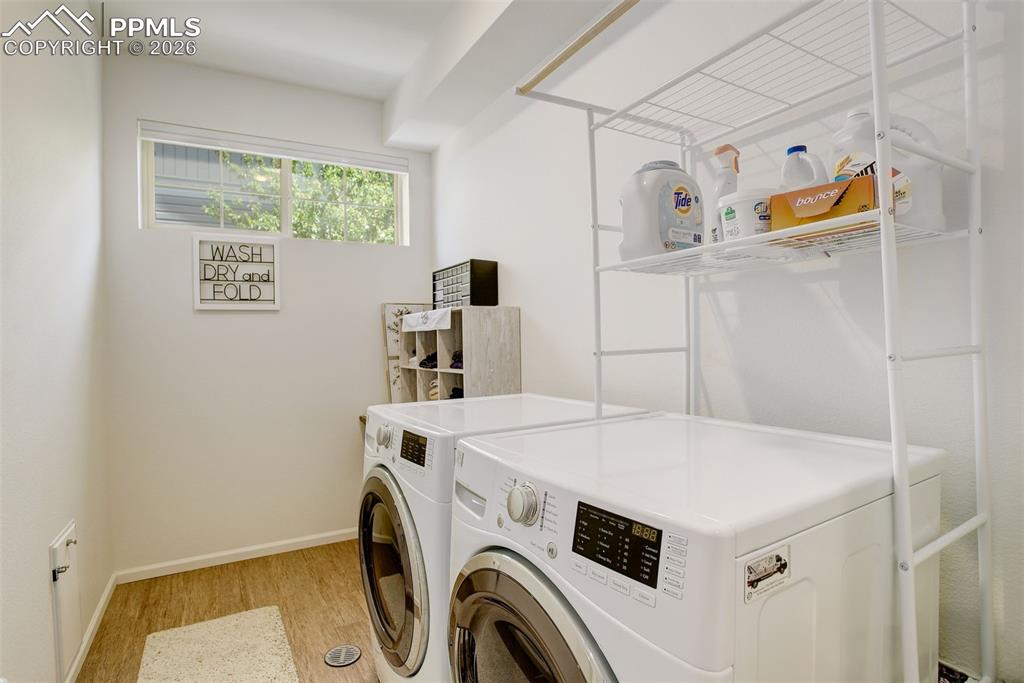 Image 23 of 29: Large laundry space with window and electric hook-ups