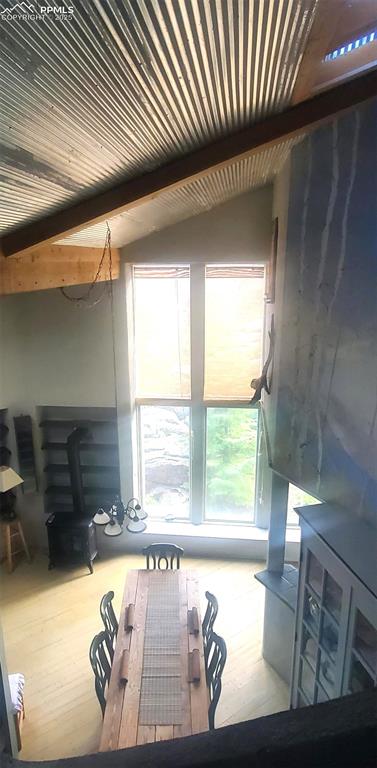 Image 9 of 14: Living area featuring beamed ceiling and light wood finished floors