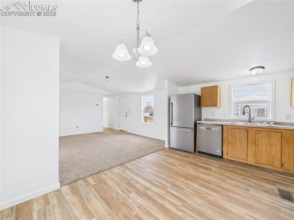 Image 10 of 34: Kitchen featuring light countertops, visible vents, stainless steel applian