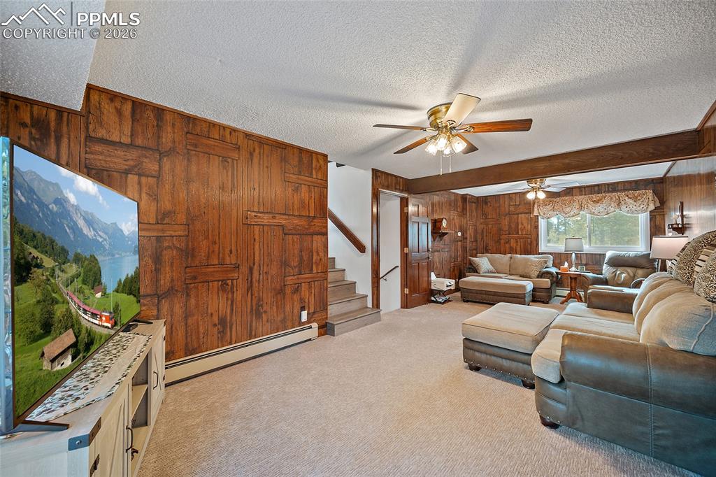 Image 15 of 49: 2nd level offers this wonderful space for family night and walks out to the