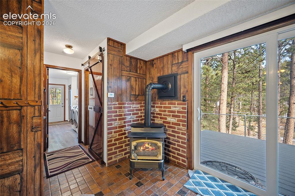 Image 18 of 50: 2nd level Family room with Wood burning stove and can be easily converted b
