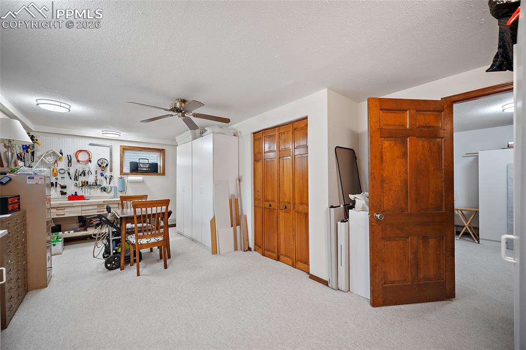 Image 20 of 49: The 4th bedroom with adjoining 3/4 bath. Being used as a hobby room.