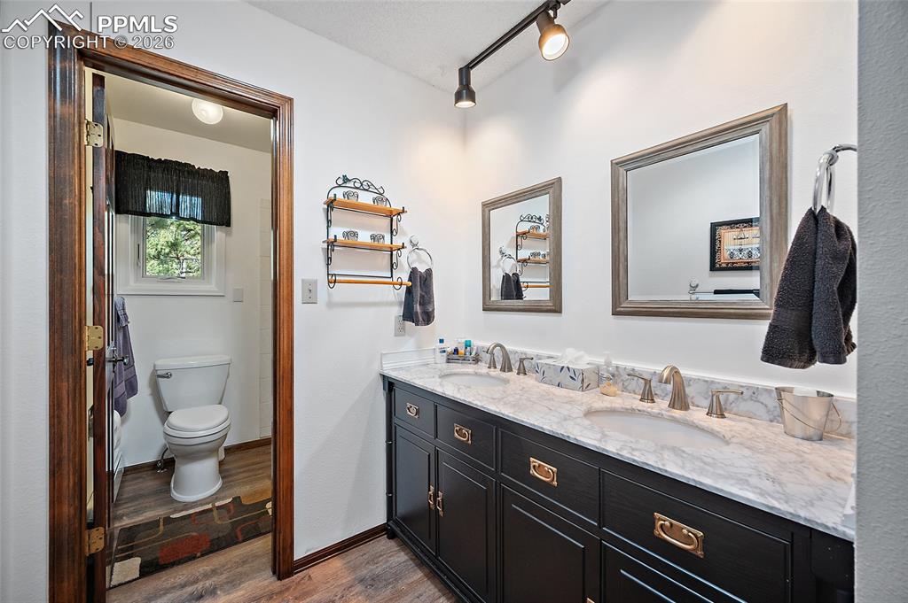Image 31 of 49: Upper-level bath with double sinks.