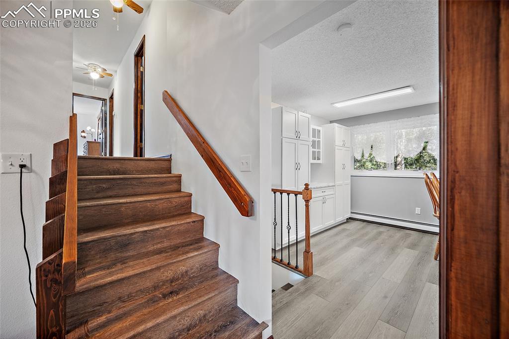 Image 33 of 49: The stairs lead to the upper-level bedrooms.