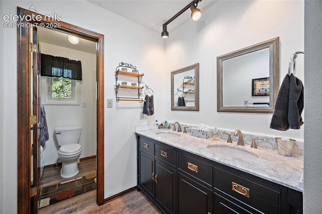 Image 34 of 50: Upper-level bath with double sinks.