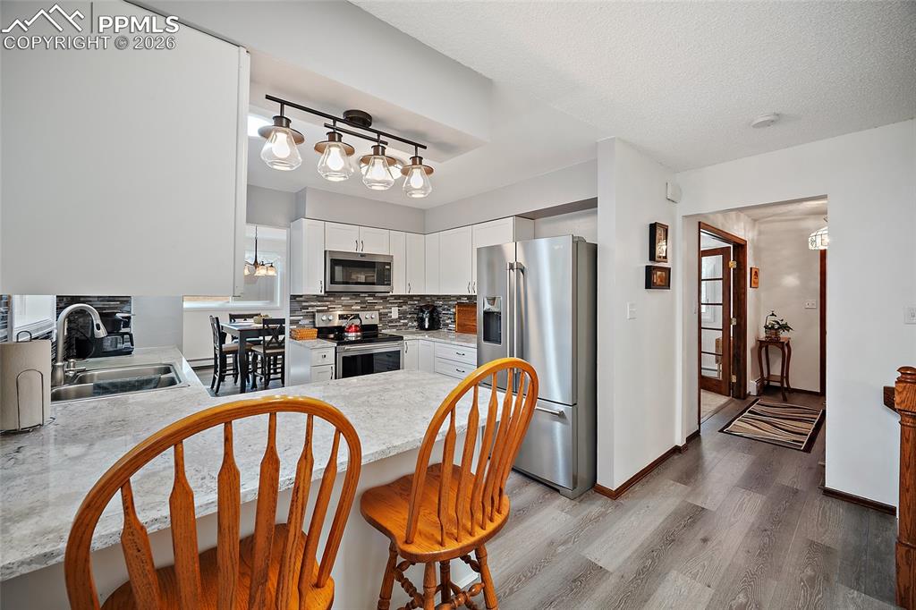 Image 8 of 49: Beautiful gourmet kitchen with all upgraded appliances and breakfast bar.