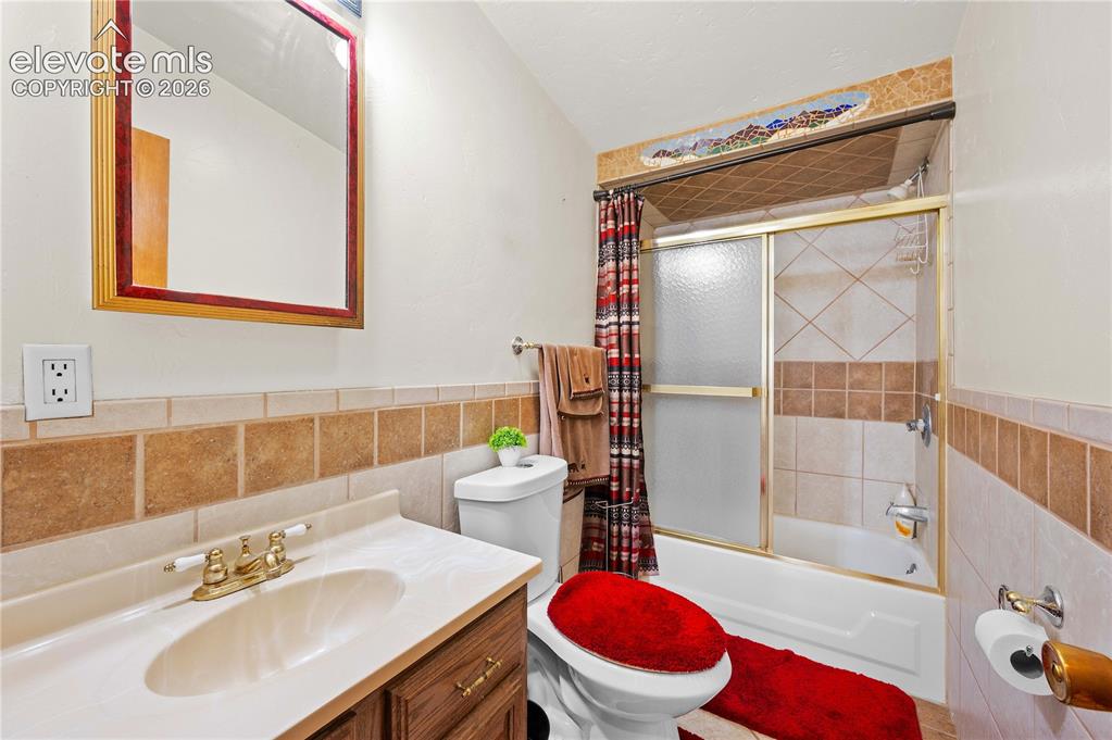 Image 17 of 48: Full bathroom with vanity, toilet, shower / bath combination with curtain, 