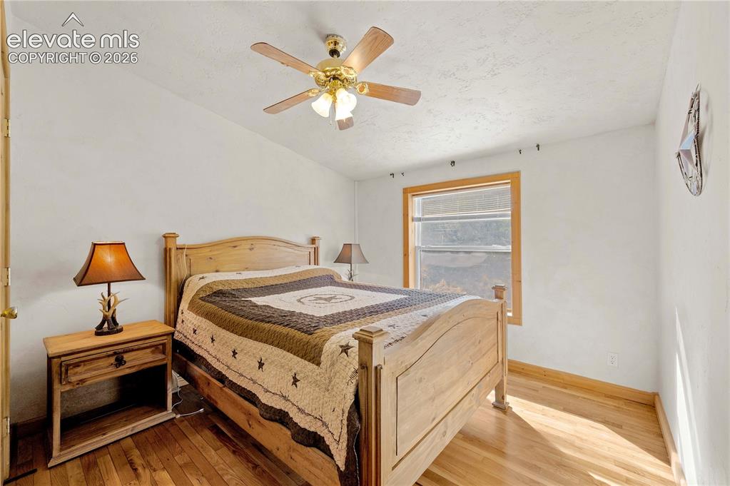 Image 19 of 48: Bedroom with light wood-type flooring and ceiling fan