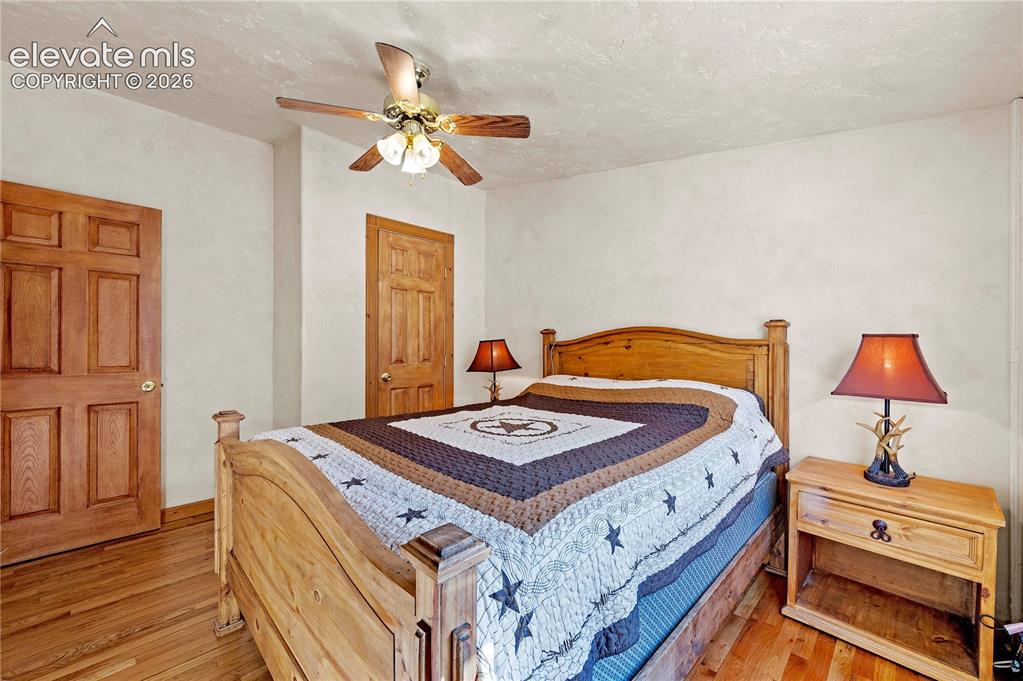 Image 20 of 48: Bedroom featuring light hardwood / wood-style flooring, a textured ceiling,
