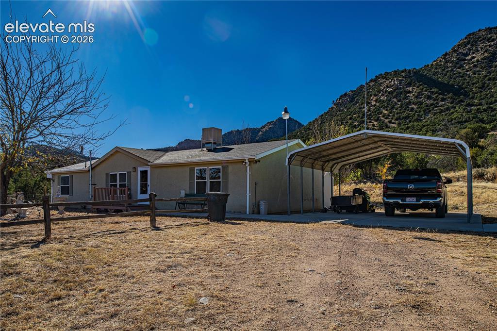 Image 30 of 48: View of front of property featuring a mountain view and a carport