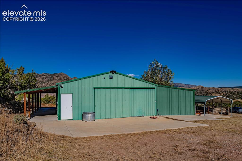 Image 32 of 48: View of outdoor structure with a mountain view and a carport