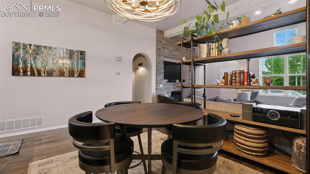 Image 11 of 50: The Dining Area is located between the Living Room and Kitchen, ideal for e