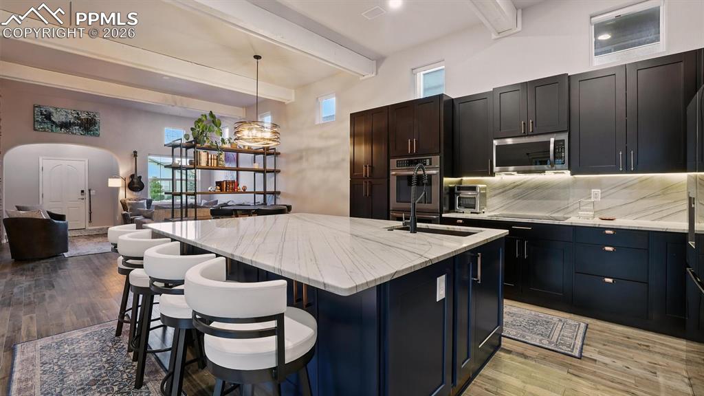 Image 14 of 50: Chef inspired Kitchen  complete with a large island, breakfast bar, pantry,