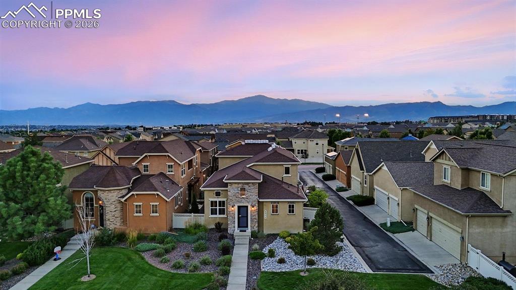 Image 2 of 50: Aerial view of the front of the home with gorgeous mountain views in the ba