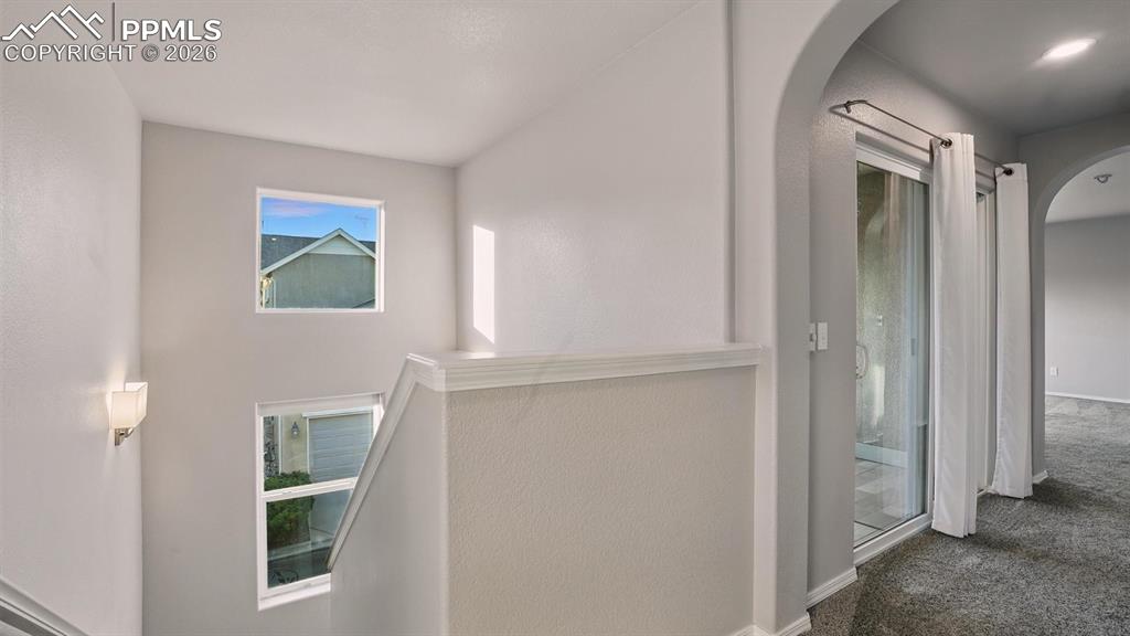 Image 26 of 50: Upper level stairs and hallway.