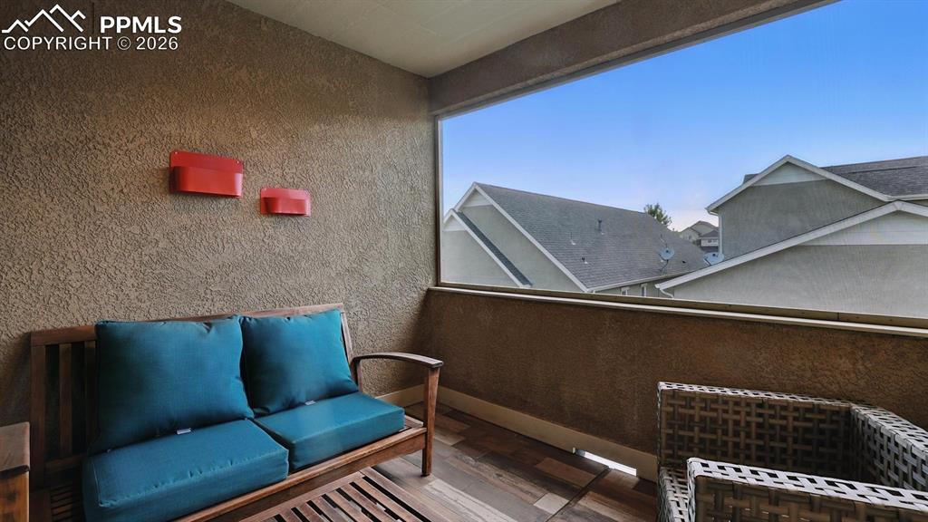 Image 28 of 50: Upper level covered balcony to enjoy the Colorado sunshine.