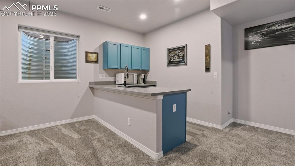 Image 39 of 50: Serve your favorite drinks and snacks at the wet bar in the Basement Theatr