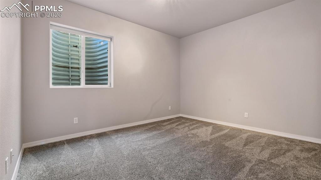 Image 44 of 50: Basement Bedroom #4 with neutral carpet.