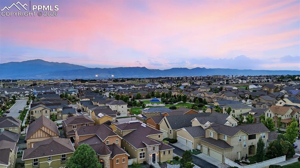 Image 48 of 50: Aerial view of home, neighborhood, and mountain views.