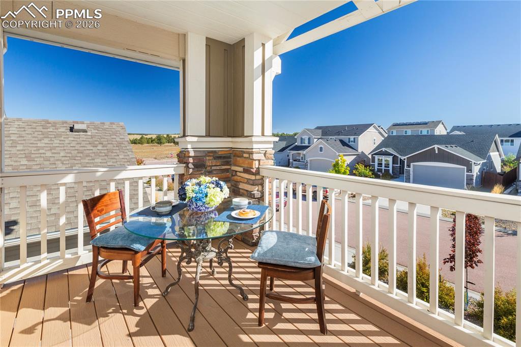 Image 10 of 50: The charming covered balcony off the primary creates a perfect spot for mor