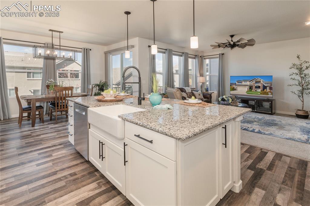 Image 23 of 50: Large island, Farmhouse sink, Moen Motion Sense Wave faucet and pendant lig