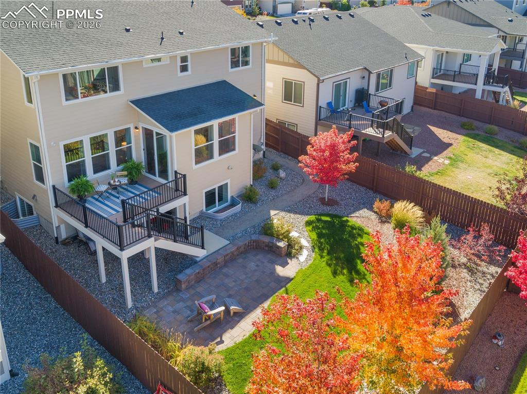 Image 3 of 50: Professionally landscaped backyard with blazing red maple trees.