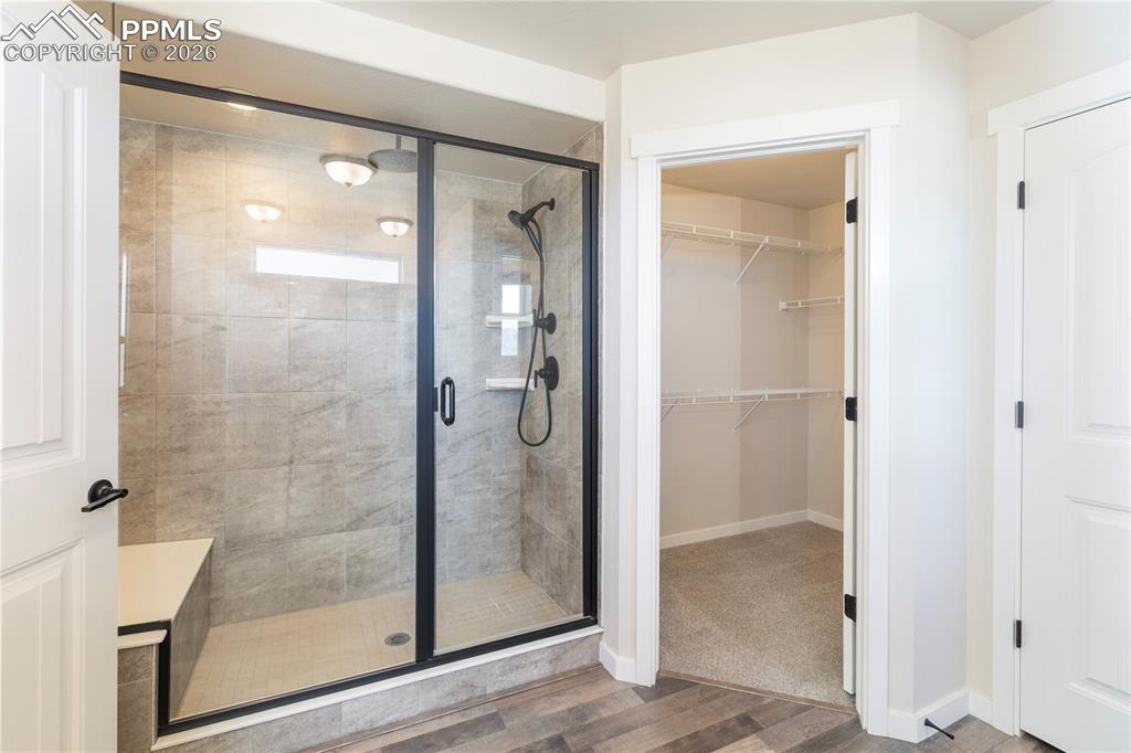 Image 36 of 50: Jr. suite bathroom has a spa shower with 2 shower heads, a bench and a walk
