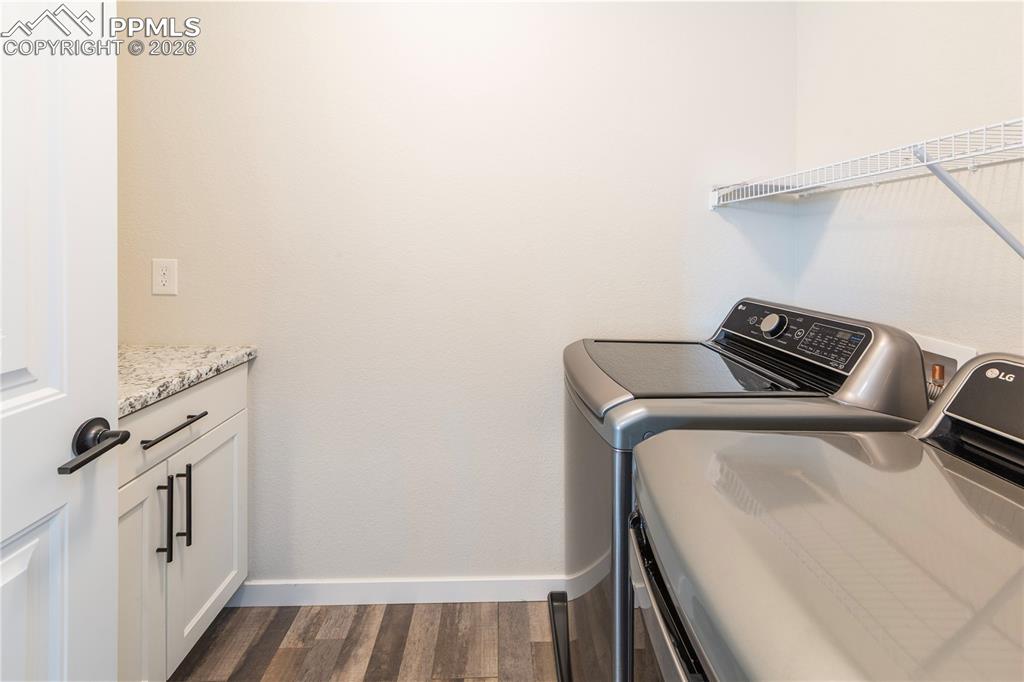 Image 41 of 50: Upstairs Laundry room with LG washer and dryer, plus more built-in storage.