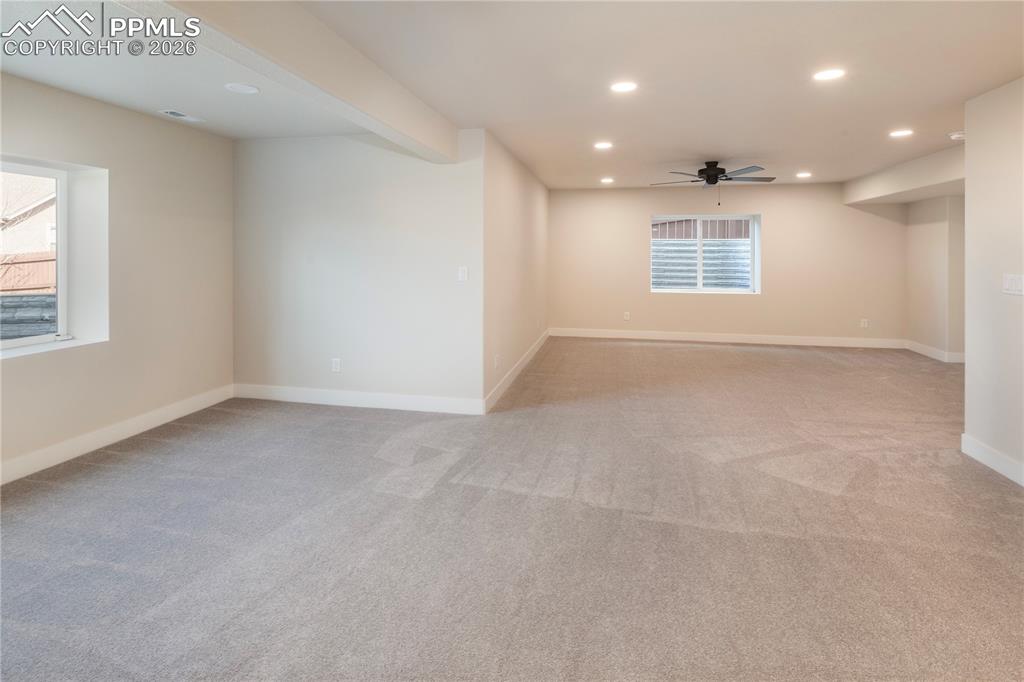 Image 46 of 50: New carpet, recessed lighting and a ceiling fan.