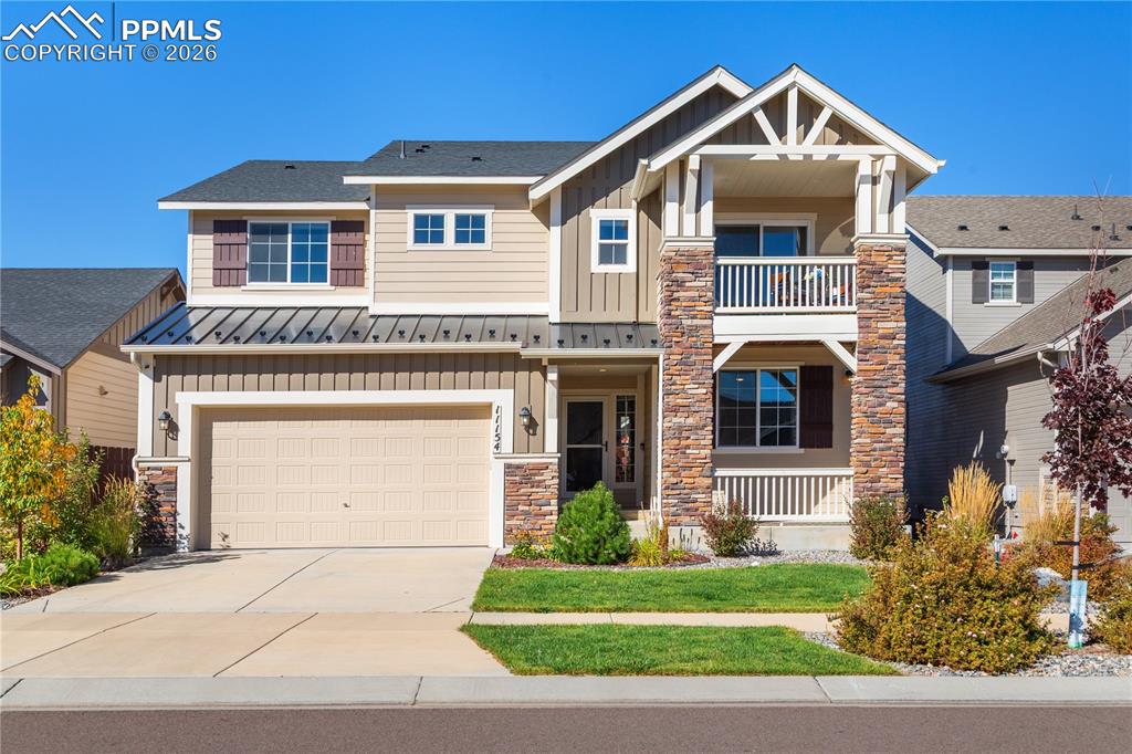 Image 9 of 50: Architectural details include a front porch and a balcony.