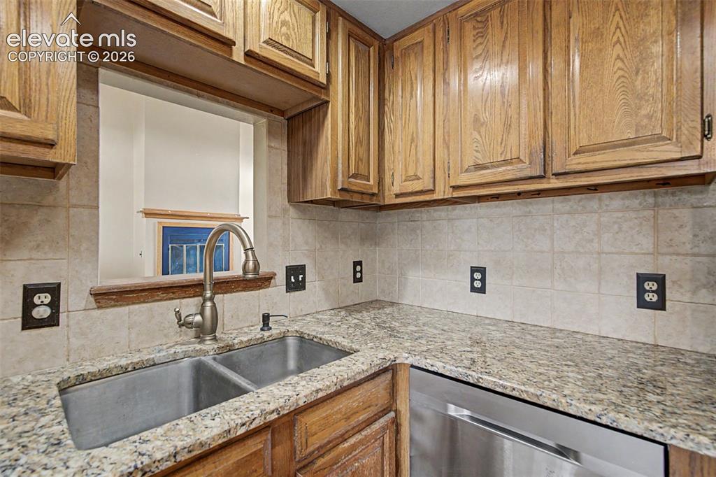 Image 18 of 44: Kitchen featuring light wood cabinetry and a pass-through window