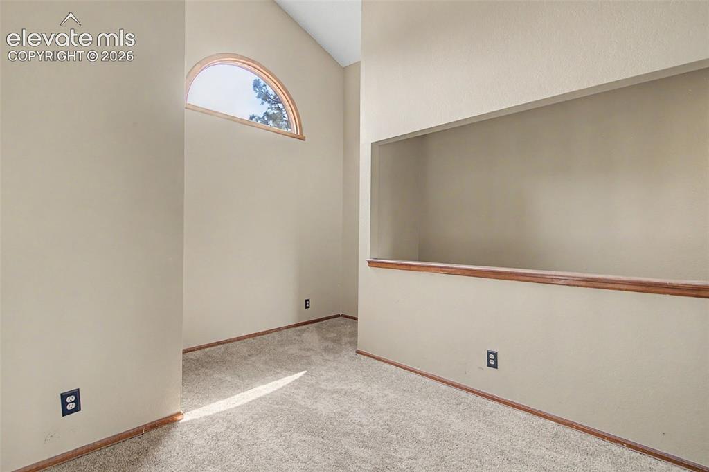 Image 23 of 44: Vaulted ceiling with an arched window