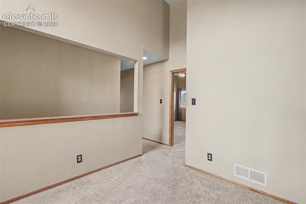 Image 24 of 44: Carpeted interior with neutral wall paint and white trim