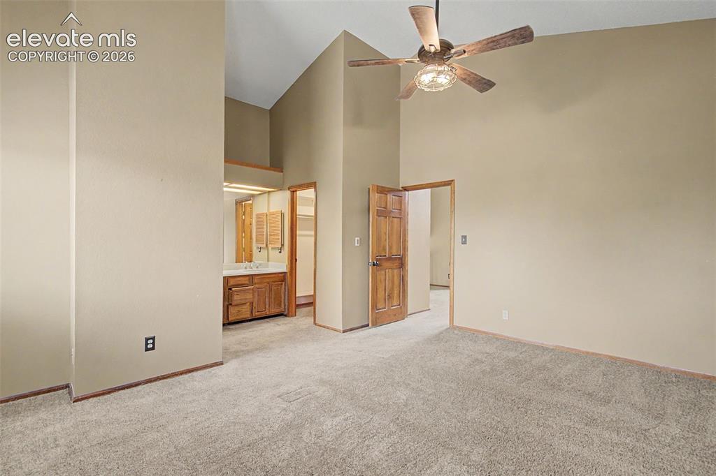 Image 27 of 44: Vaulted ceilings with a ceiling fan light fixture