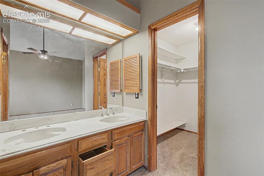Image 37 of 44: Double vanity featuring two integrated sinks set in a light-toned counterto