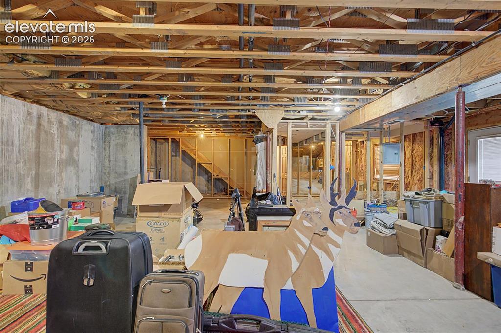 Image 40 of 44: Unfinished basement featuring exposed joists, concrete foundation walls, an