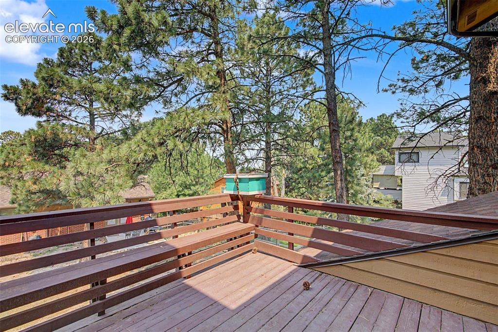 Image 42 of 44: Expansive outdoor deck featuring wood-finish flooring and an integrated woo
