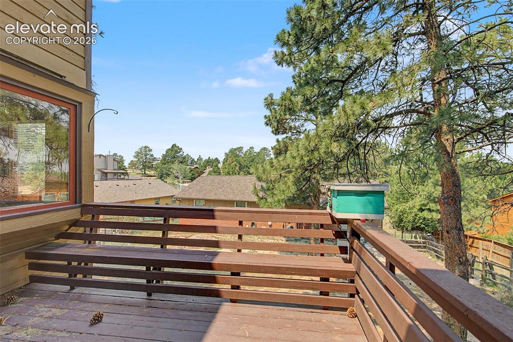 Image 43 of 44: Elevated wood deck featuring integrated bench seating and a wooden railing