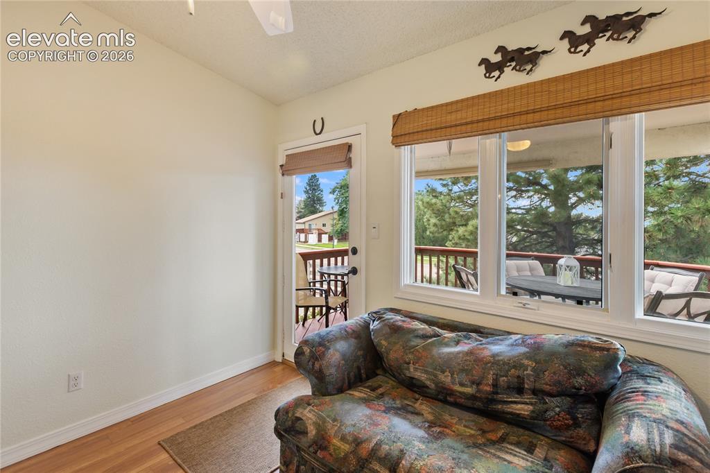 Image 28 of 43: This bonus room/office has great views and walks out to the covered deck.
