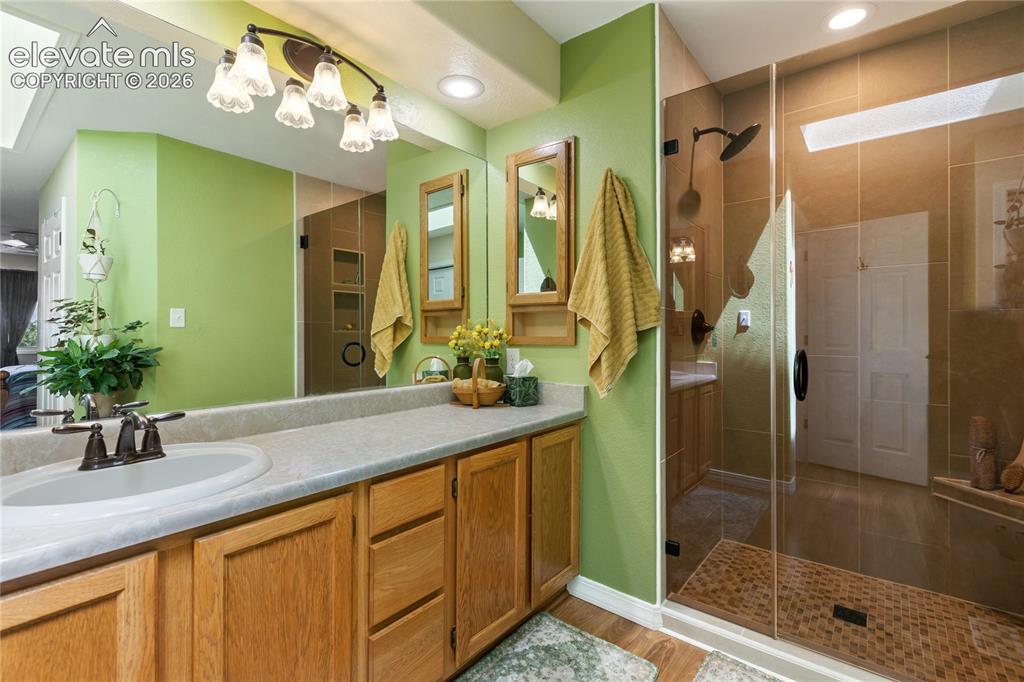 Image 34 of 43: The primary bathroom has a spacious vanity and features a recently updated 