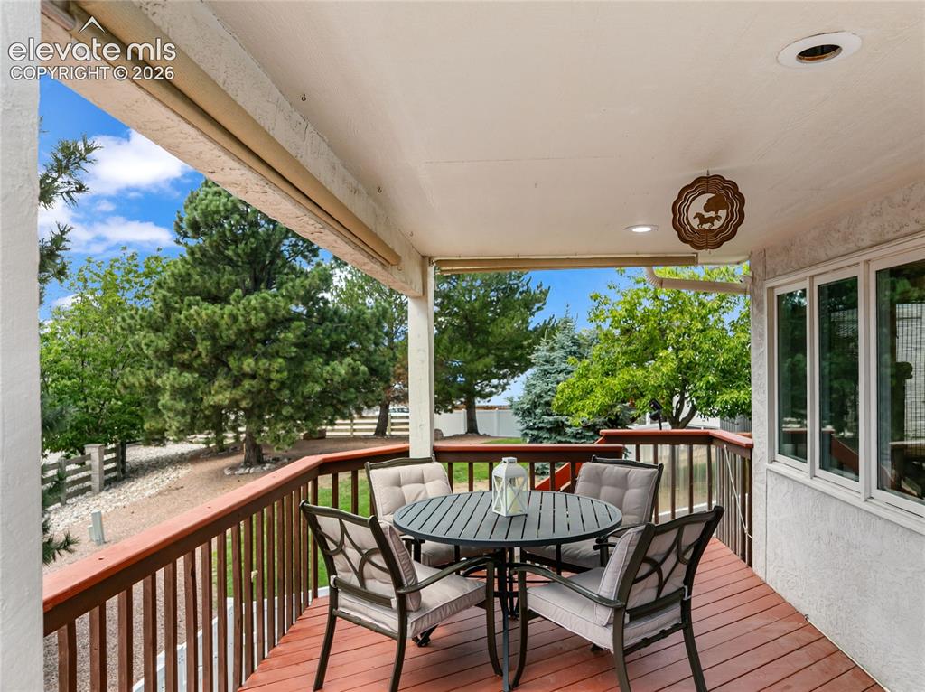 Image 7 of 43: Enjoy mountain views on this covered deck with retractable sun shades!