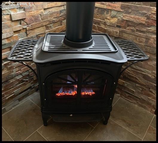 Image 8 of 33: Cozy gas stove in the dining area