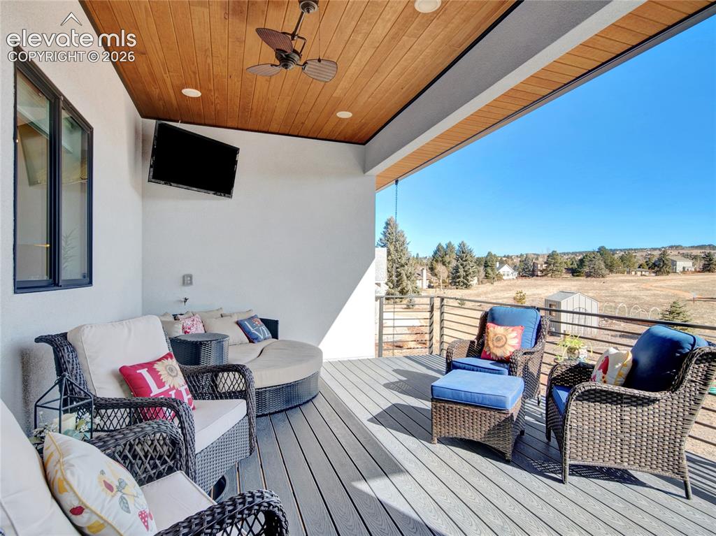 Image 18 of 49: Covered outdoor living area featuring a wood-finish ceiling with recessed l