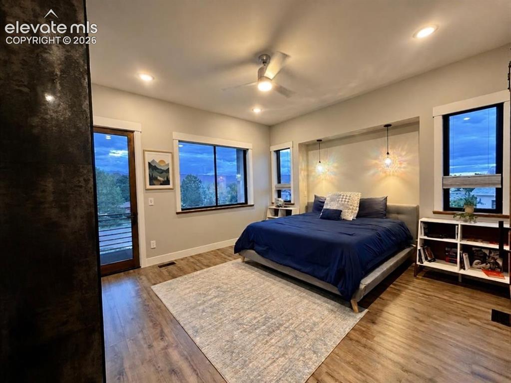 Image 20 of 49: Wood-finish flooring, recessed lighting, and a ceiling fan