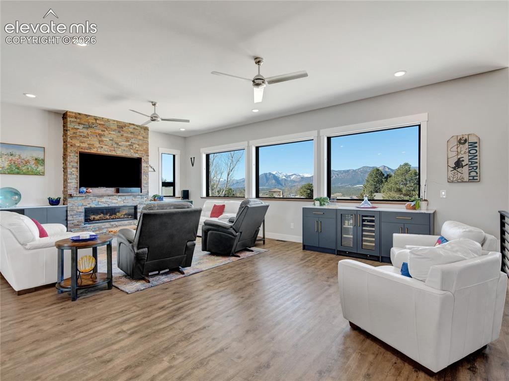 Image 5 of 49: Spacious living area featuring expansive windows showcasing mountain scener